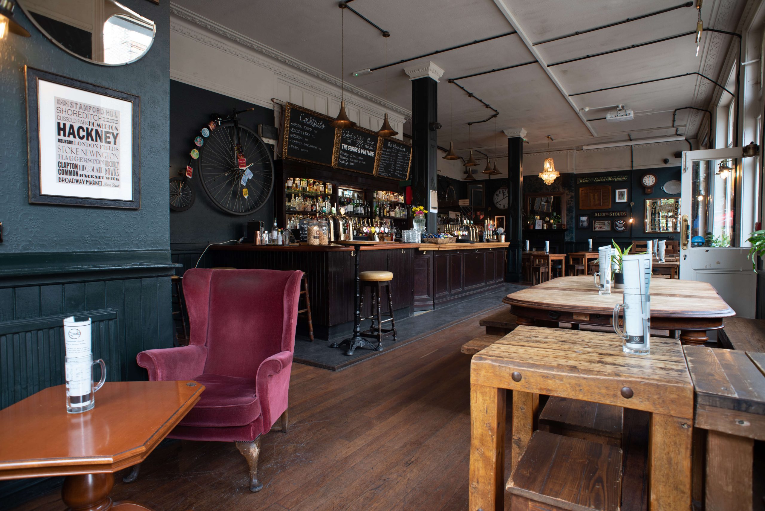 The long wooden bar, velvet chair and dining tables