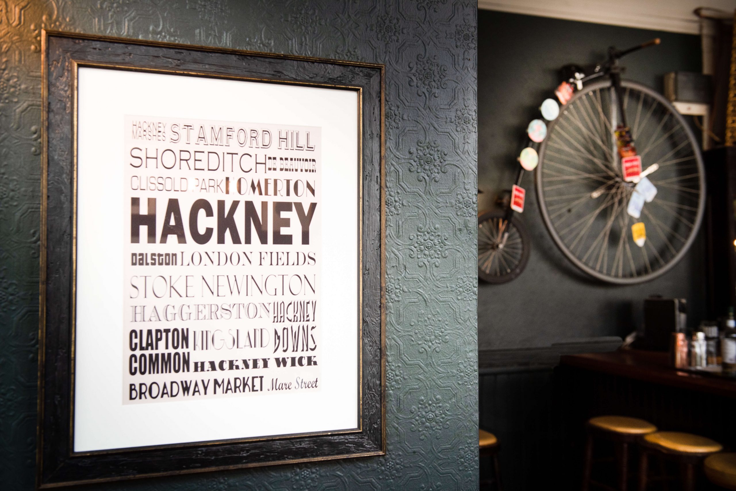 East London on the wall, a penny-farthing beside it