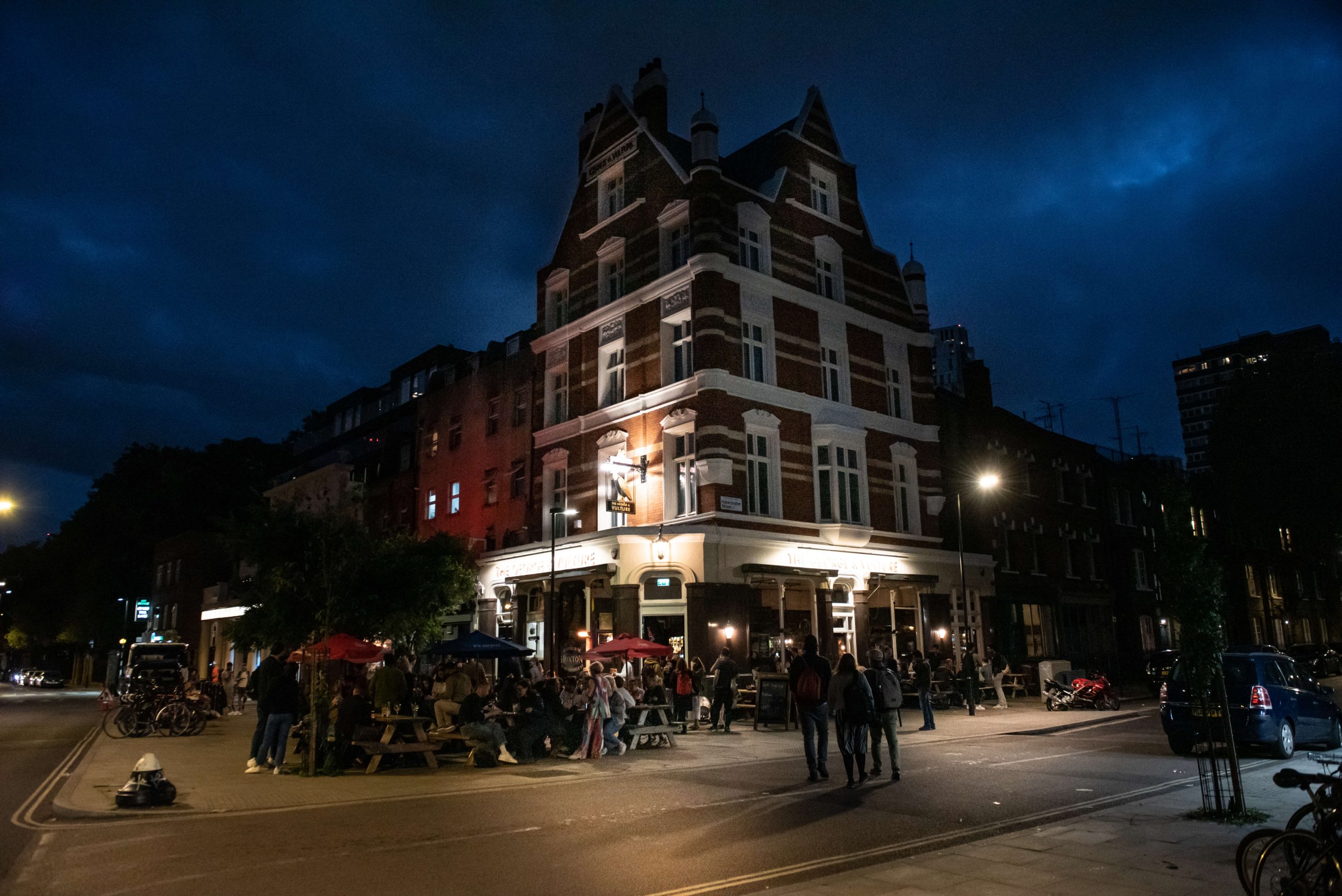 The George & Vulture lit up on the corner at dusk
