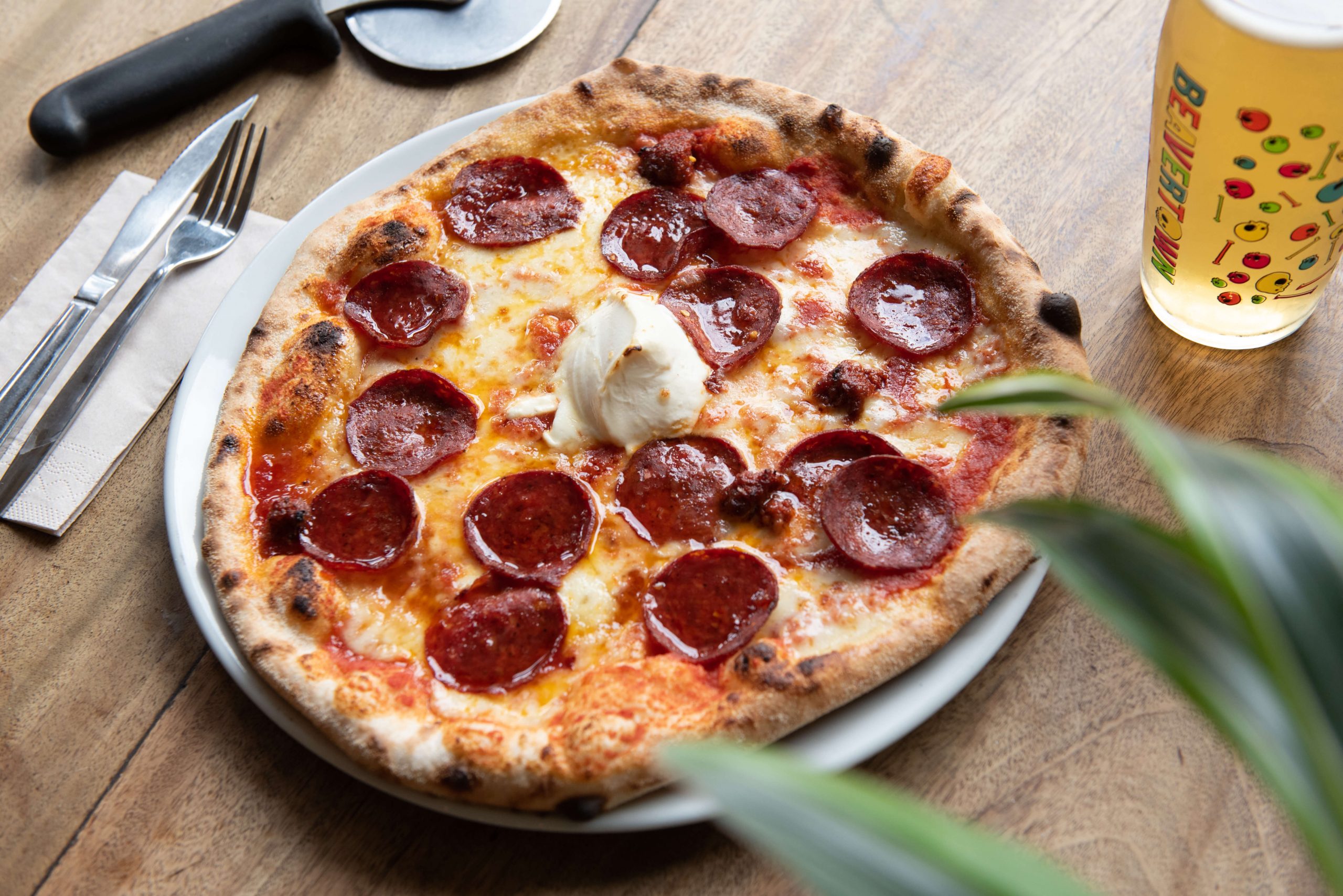 Pepperoni and mascarpone sourdough pizza with a pint