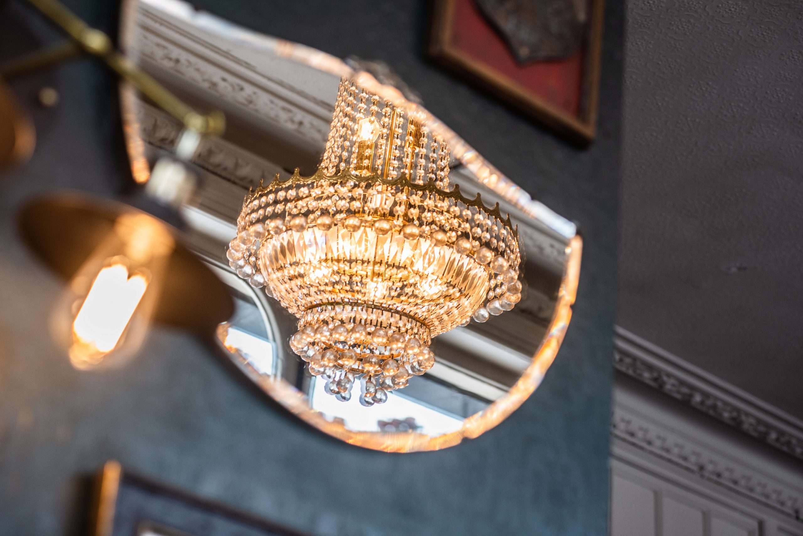A chandelier caught in a gilt mirror