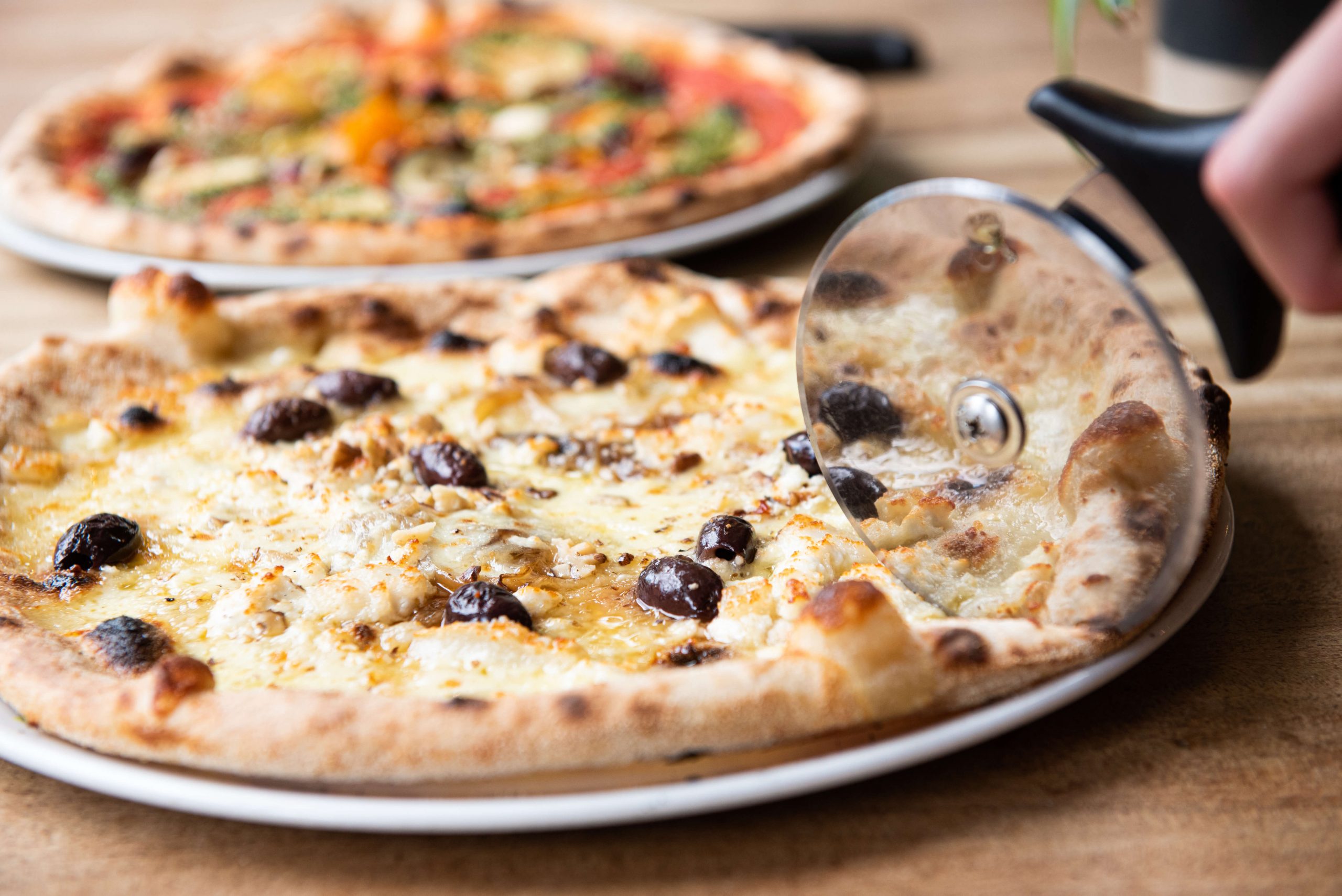 Sourdough pizza, olives and a blistered crust